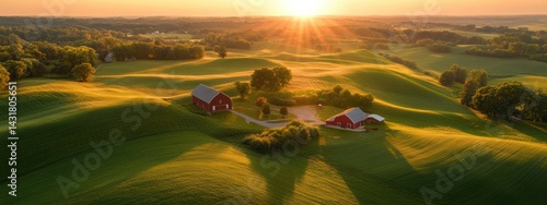 A picturesque rural landscape at sunrise with rolling hills and red barns.