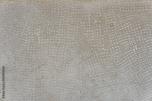 Concrete wall with traces of impacts and cracks. Abstract construction background.