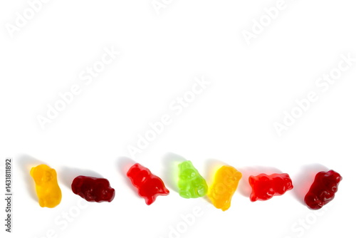 Bild auf Leinwand There are many small jelly candies lying on a white background.