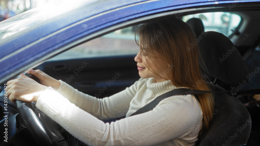 Woman driving car in urban city street showing concentration and focus while enjoying the outdoor experience in a modern vehicle during daytime travel.
