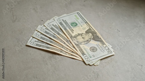 Obraz na płótnie United states twenty-dollar banknotes fanned out on a concrete surface imply financial themes and monetary implications. w salonie