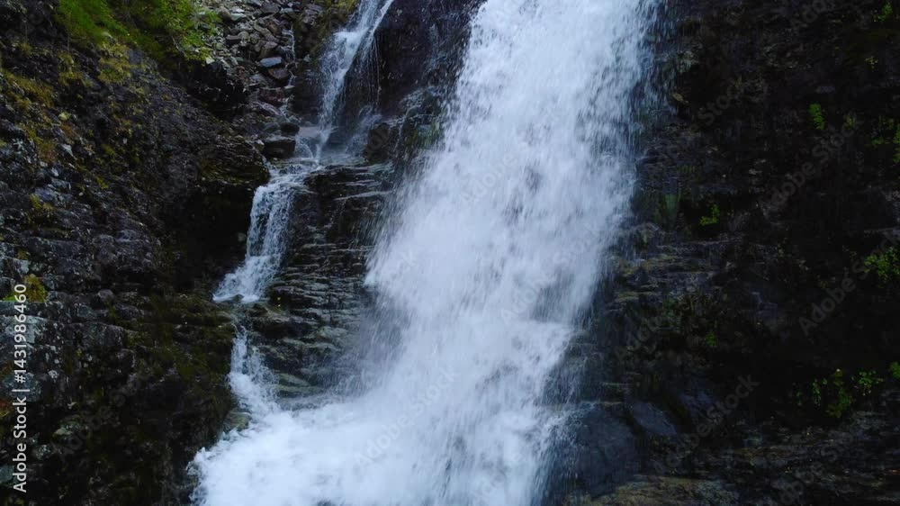 A beautiful waterfall in the autumn mountains beyond the Arctic Circle in the north, in Khibiny, Murmansk region. Panoramic view of a beautiful waterfall in the mountains in autumn, Kola Peninsula 4К A beautiful waterfall in the autumn mountains beyond the Arctic Circle in the north, in Khibiny, Murmansk region. Panoramic view of a beautiful waterfall in the mountains in autumn, Kola Peninsula 4К