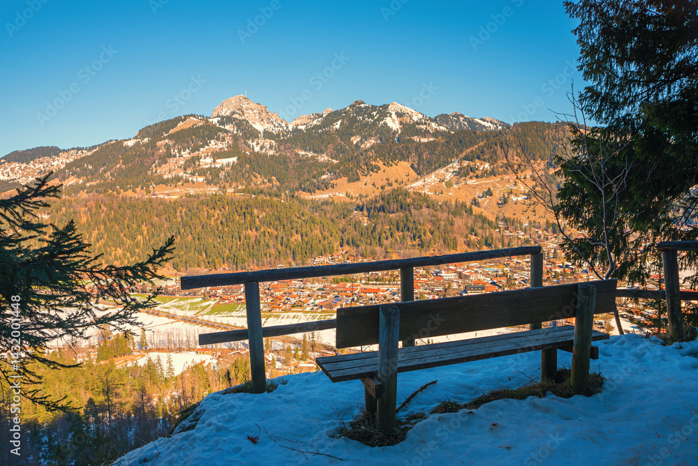 lookout point with bench above resort Bayrischzell, view to Wendelstein mountain.