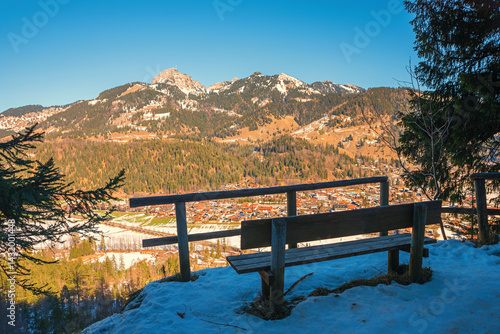 Obraz na płótnie lookout point with bench above resort Bayrischzell, view to Wendelstein mountain. w salonie