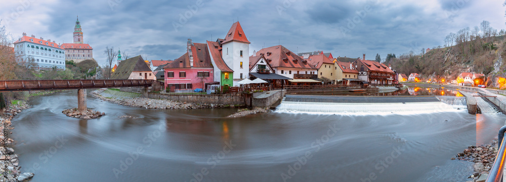 Panoramic view of historic buildings and riverfront along the Vltava River in Cesky Krumlov, Czech Republic