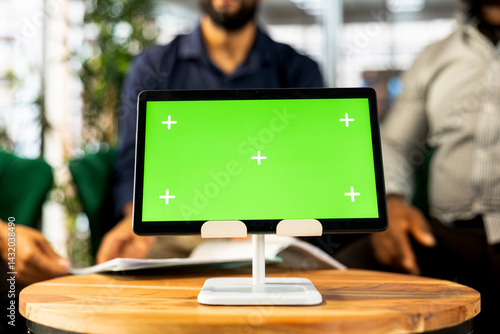 Board of directors in office maintaining strong relationships with business partners, looking at metrics on green screen tablet. Company director shows shareholders data on chroma key device, closeup