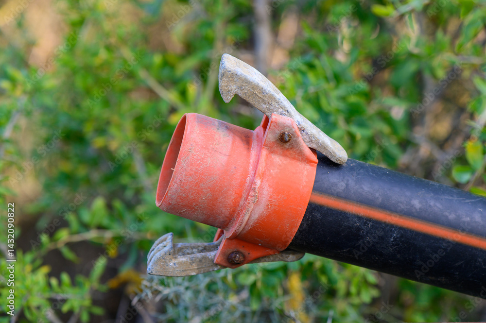 Macro shot of a plastic water pipe with quick-connect fittings, demonstrating ease of installation for plumbing systems. Clear view of the connection mechanism.
