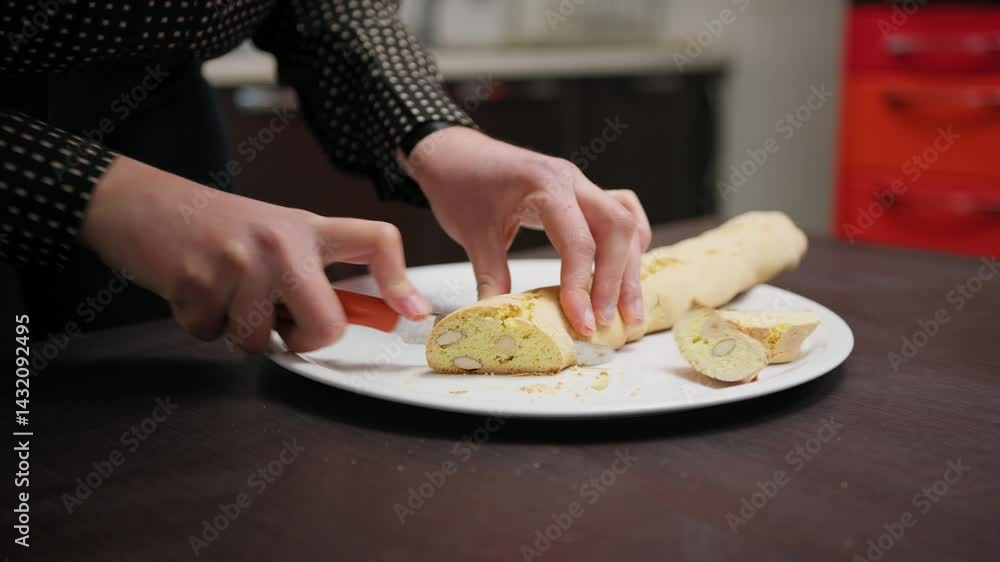 In a Home Kitchen A Hand Cuts Cantucci Biscuits Before Second Baking In Oven In a Home Kitchen A Hand Cuts Cantucci Biscuits Before Second Baking In Oven