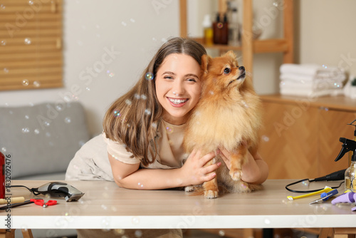 Female groomer with cute Po...