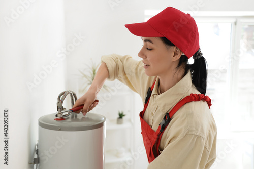 Female worker with wrench i...