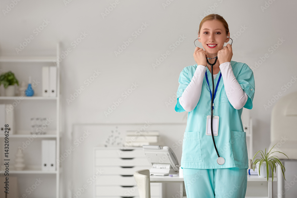Happy female doctor with stethoscope and badge in clinic