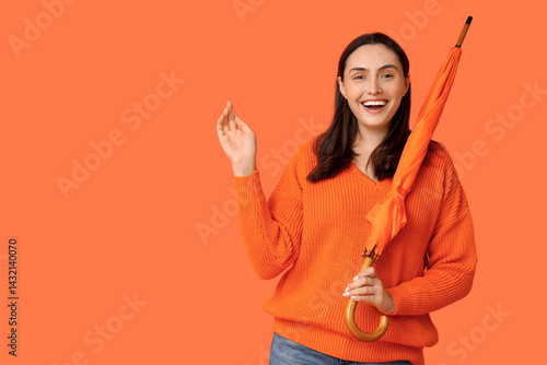 Happy young woman with umbr...
