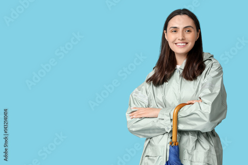 Happy young woman with umbr...
