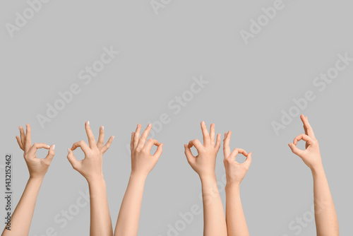 Female hands showing OK on light background