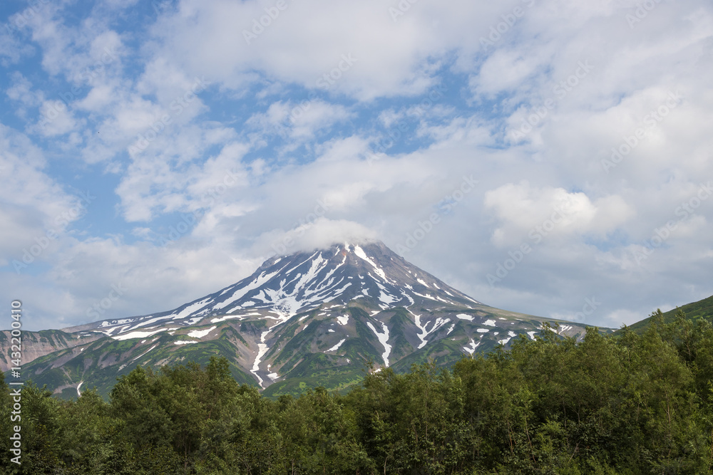 View of the volcano. Travel and tourism on the Kamchatka Peninsula. Beautiful nature of Siberia and the Russian Far East. Vilyuchinsky Volcano (Vilyuchinskaya Sopka), Kamchatka Territory, Russia.