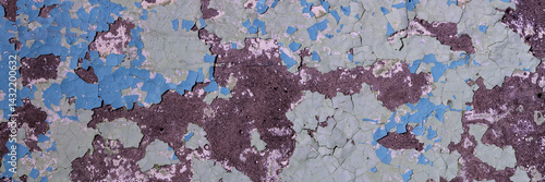 Obraz na płótnie Peeling paint on the wall. Panorama of a concrete wall with old cracked flaking paint. Weathered rough painted surface with patterns of cracks and peeling. Panoramic texture for background and design. w salonie