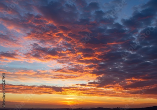 Gentle vibrant hues sky end day dramatic accumulated clouds appearing if ignited blue upper atmosphere illuminated magenta orange yellow tones dark shaded areas weather conditions suitable digital