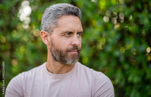 Mature man with hairstyle. Hair fashion man. Copy space. Stylish man with graying hair in shirt. Handsome man outdoor portrait. Portrait face stylish model. Fashion male has serious face