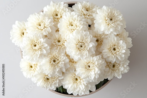 White gerbera daisies bouquet fills gray pot, sitting on neutral surface, as table centerpiece