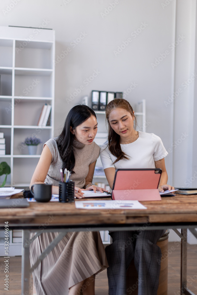 Two business asian women or an accountant team are analyzing data charts, graphs, and a dashboard on a laptop screen in order to prepare a statistical report and discuss financial data in an office
Two business asian women or an accountant team are analyzing data charts, graphs, and a dashboard on a laptop screen in order to prepare a statistical report and discuss financial data in an office