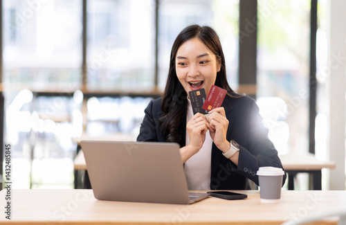 Wallpaper Mural Transfer money online business asian woman using bank payment card. Hands input credit card data using phone and laptop.
 Torontodigital.ca