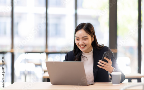 Free Download Happy young business woman manager talking consulting client on cell phone working on laptop in office. Busy woman professional business making call on cell using computer sitting at desk
 - GFXLoad