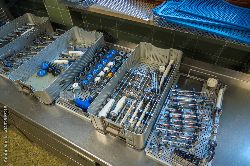 Instrument trays for a shoulder prosthesis stand on an operating table