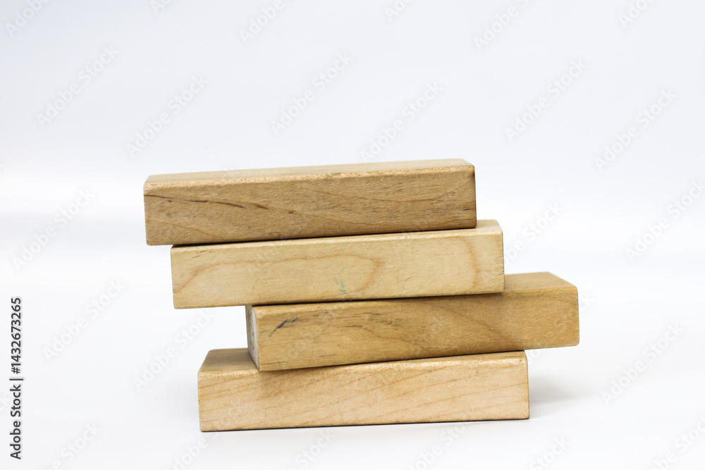 A pile of four wooden blocks on the soft white background. A pile of four wooden blocks on the soft white background.