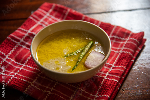 Panta bhat or pakhala or fermented rice soup with water, green chillies and onion in a bowl. Staple food in Eastern India. Close up, selective focus.	