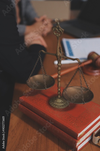 Judge gavel with Justice lawyers having team meeting at law firm background. Concepts of Law and Legal services.