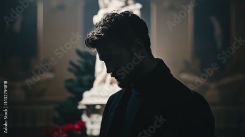 Contemplative Man in Silhouette Amidst Artistic Sculpture Background