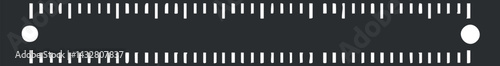 White ruler with precise measurement markings on a black background, used for measuring length and drawing straight lines