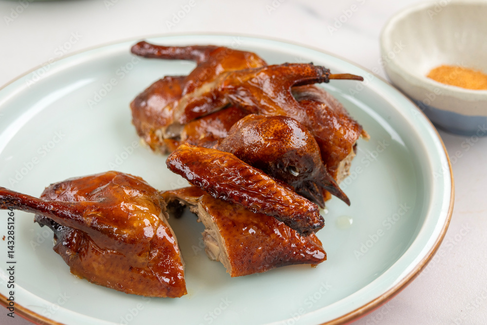 Crispy roasted pigeon on a plate