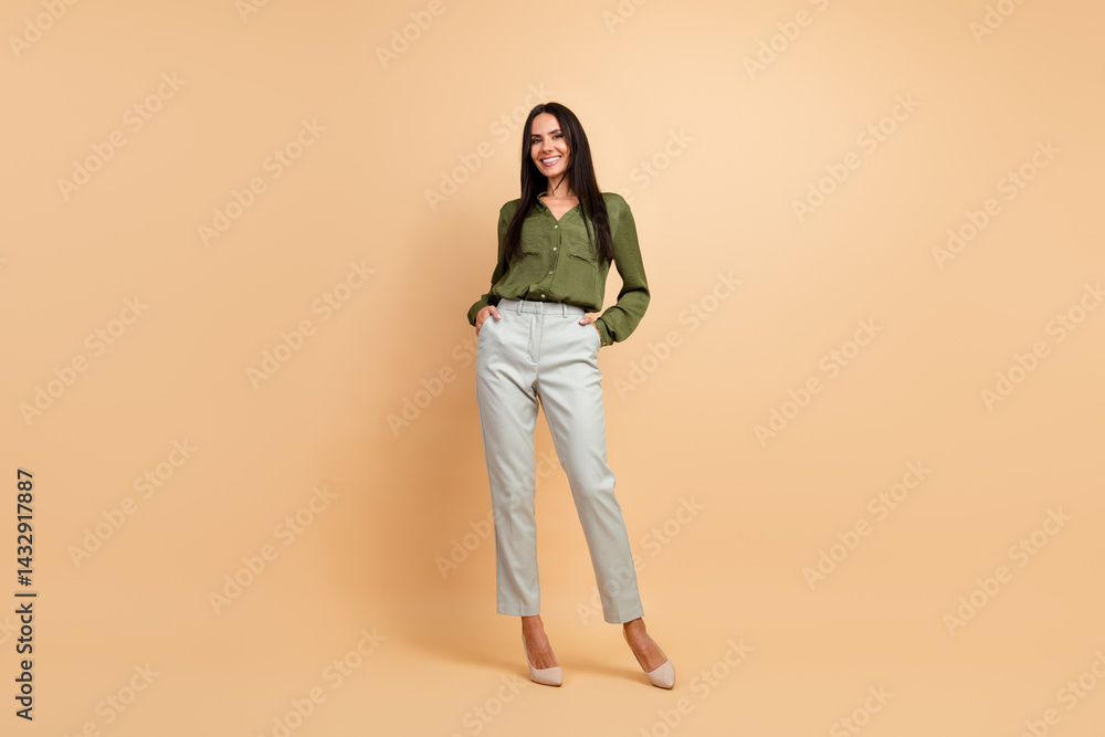Confident businesswoman posing with elegance in formal attire, showcasing professional style and sophistication against a beige background
