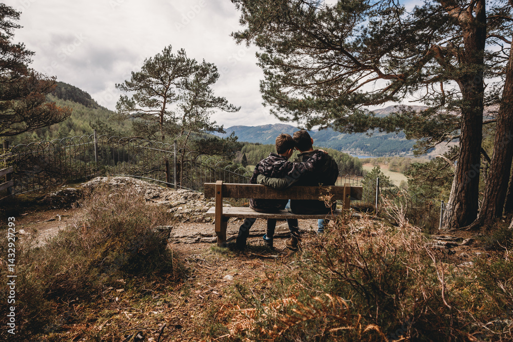 father and son sitting on the bench in the forest , parenting journey