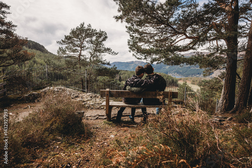 Obraz na płótnie father and son sitting on the bench in the forest , parenting journey w salonie