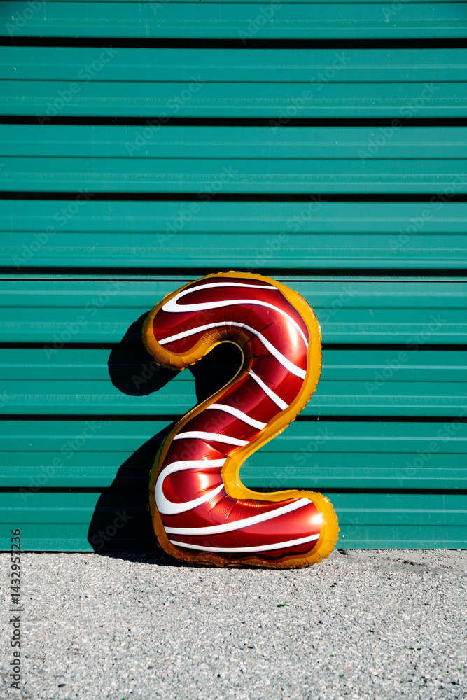 foil balloon in the shape of number 2 outdoors