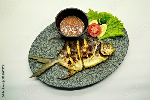 Grilled spadefish (bawal bintang) served with spicy seafood sambal. A savory Indonesian dish rich in flavor, perfect for traditional seafood lovers.