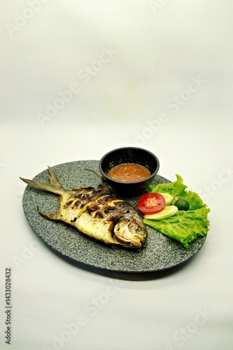Grilled spadefish (bawal bintang) served with spicy seafood sambal. A savory Indonesian dish rich in flavor, perfect for traditional seafood lovers.