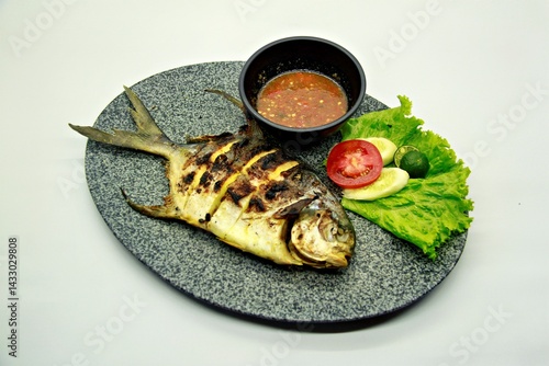 Grilled spadefish (bawal bintang) served with spicy seafood sambal. A savory Indonesian dish rich in flavor, perfect for traditional seafood lovers.