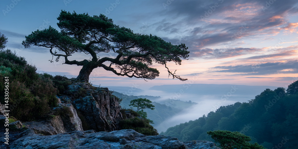 Obraz premium Lone tree on rocky cliff overlooking misty valley at sunrise, showcasing serenity and nature's majesty, ideal for peaceful or travel themes