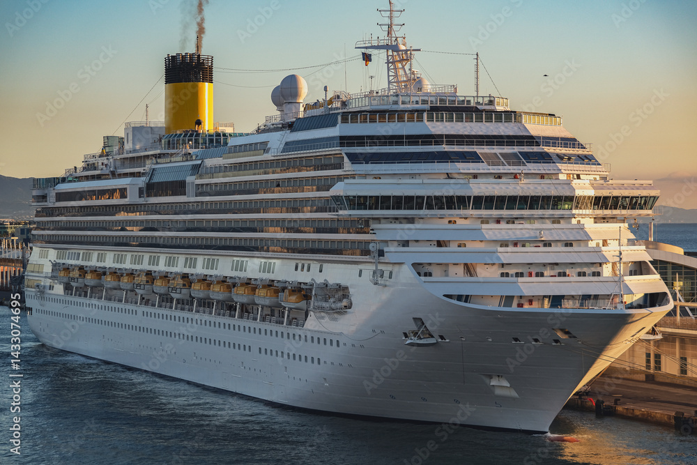 Mega family cruiseship cruise ship liner Favolosa docked at terminal in Barcelona, Spain during breathtaking sunset sunrise twilight blue hour dusk dawn silhouette scenic panorama