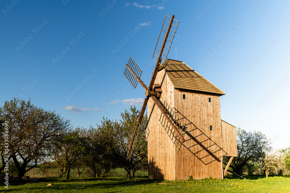 scenic countryside landscape with windmill and spring colors