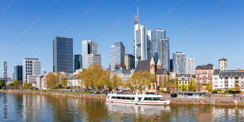 Frankfurt skyline skyscrapers with banks on River Main panorama with excursion boat in Frankfurt, Germany