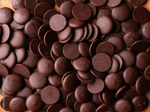 Dark Chocolate COUVERTURE chips Pistols buttons. Confection and pastry concept.