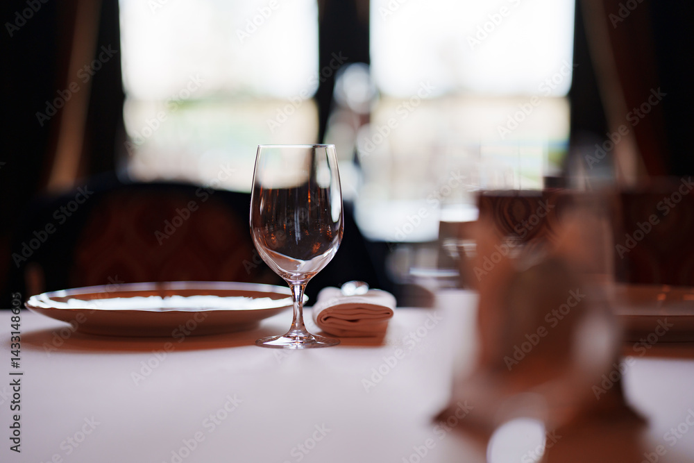 Obraz premium An empty wine glass on a table served for a banquet. 