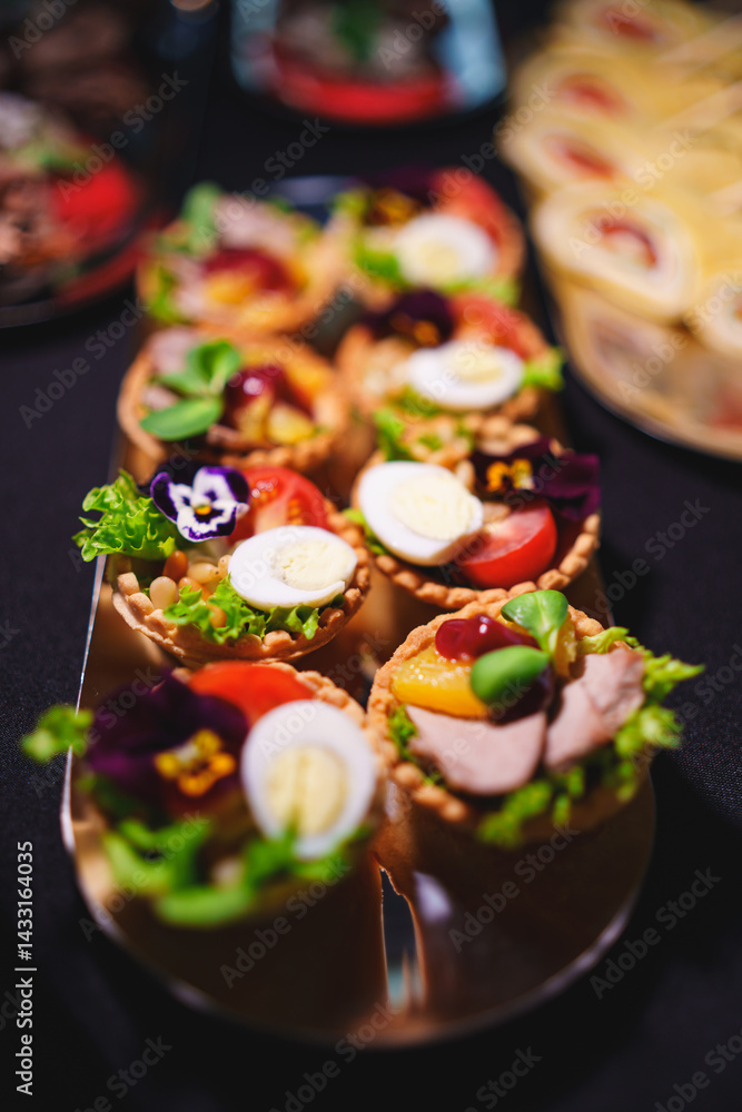 tartlets with pate and salad garnished with flowers. Delicious appetizers.