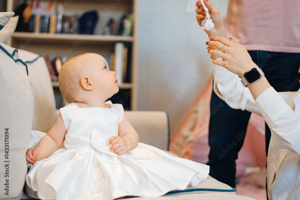 Cute little girl in a fluffy fancy pink dress sitting