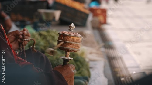 Close-Up of Hand Spinning Tibetan Prayer Wheel