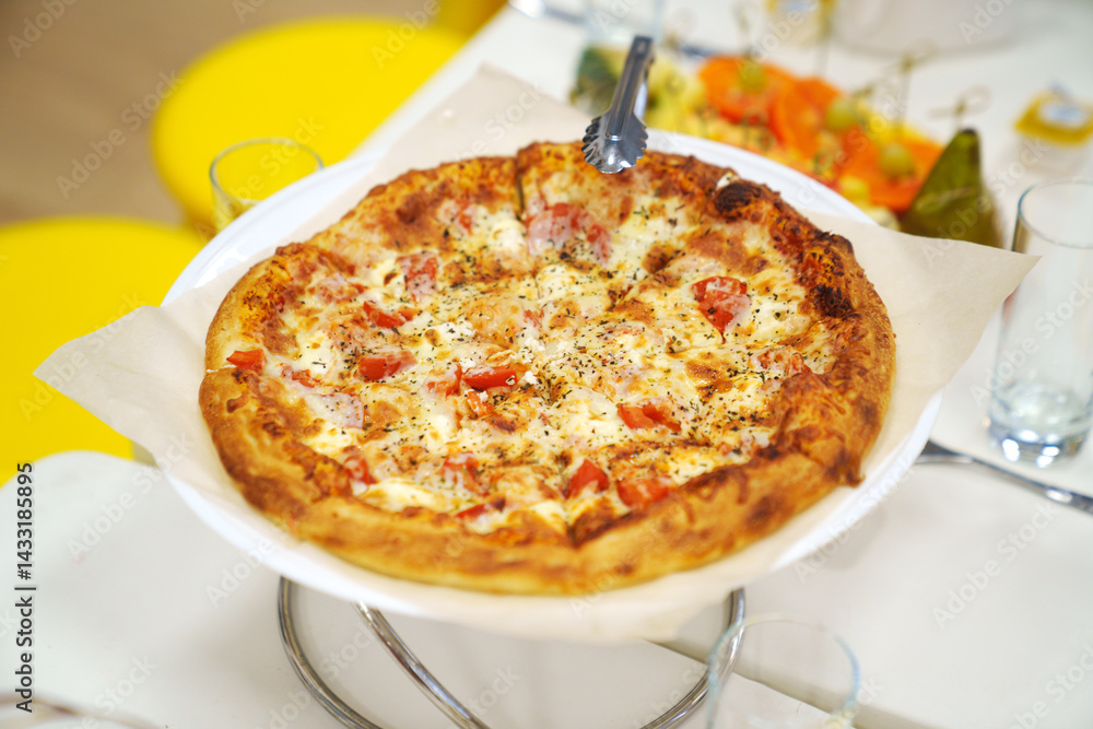 close-up. A large margherita pizza on the table with appetizers for the holiday.